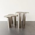 Sleek Modern Coffee Tables With Metallic Cylindrical Legs And Round Smooth Tops