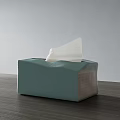 Light Green Household Tissue Box With Pulled Out Paper On Wooden Tabletop