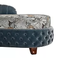 Navy Blue Tufted Chaise Lounge with Floral Patterned Cushion and Decorative Pillows