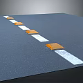 A Row Of Orange And White Speed Bumps On Black Road Surface