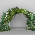Lush Green Event Entrance Arch Decorated With Tropical Foliage And White Flowers