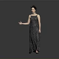 Elegant Woman In Patterned Long Dress Standing With Extended Arm On Gray Background