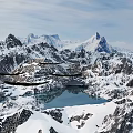 Natural Garden Landscape With Snowy Mountain Peaks And Calm Lake Reflections