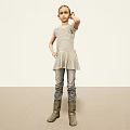 Woman In Striped Dress Jeans And Boots Standing Against Light Background With Hand On Head
