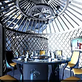 Modern Restaurant Interior With Elegant Chandeliers Blue Booth Seats And Decorative Wooden Partitions