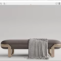 Gray Upholstered Ottoman With Gold Metal Legs And Striped Throw Blanket