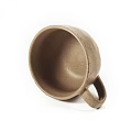 Speckled Beige Ceramic Cup With Handle In Simple Design Isolated On White