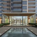 Modern High Rise Apartment Main Entrance With Glass Canopy Water Pool And Landscaped Plants