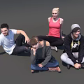 Group of four people casually sitting on gray floor smiling and relaxing