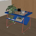 Blue Two Tier Side Table With Wheels Green Plant And Magazine On Top