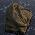 Soft Brown Knitted Sweater Lying On Dark Marble Textured Surface