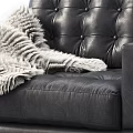Stylish Black Leather Accent Chair with Tufted Back White Fur Throw and Wooden Legs