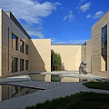 Modern Architectural Courtyard With Pool Statue Grass And Blue Sky