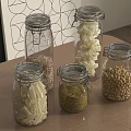 Clear Glass Spice Jars With Grains Beans And Pasta On Wooden Kitchen Countertop