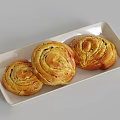 Three Golden Swirled Bread Rolls on White Rectangular Tray with Grey Background