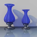 Two Blue Glass Vases With Black Bases On Gray Tabletop Light Gray Background