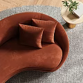 Modern Curved Orange Sectional Sofa With Green Cushion And Fireplace On Green Wall