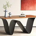 Elegant Dining Table With Black Wavy Legs Brown Tabletop White Vase And Stack Of Books