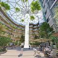 Modern Building Atrium Garden With Glass Dome Central Water Column Green Plants And Seating Areas
