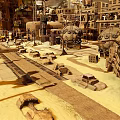 Futuristic Industrial Landscape With Large Mechanical Structures Multi Level Buildings And Vehicle Wrecks