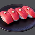 Four Pieces of Fresh Tuna Sushi on Black Plate with Wasabi