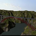 Red Arch Bridge Spanning River Between Green Mountains With Blue Sky And Lush Vegetation
