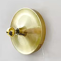 Golden Round Base Wall Lamp With Modern Minimalist Sleek Design Mounted On White Wall