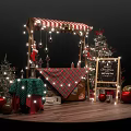 Festive Christmas Market Stall With Red White Striped Awning Lights Trees And Gifts