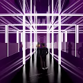 Elevator Hallway with Purple Illuminated Lines and Mirror Surfaces Where People Walk Through Modern Design