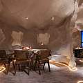 Unique Restaurant Interior Design With Cave Like Ceiling Blue Art Bar Counter And Black Stools
