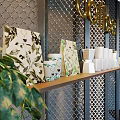 Modern Cafe Interior With Coffee Sign Metal Grid Wall Green Plants Wooden Bar And Black Stools