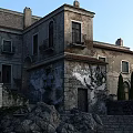 Ancient European Architecture with Stone Walls Balconies Windows Stone Steps Surrounding Rocks and Trees