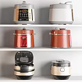 Different Colored Kitchen Appliances Displayed On White Shelves With Various Styles