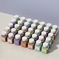 Decorative Ornament Set Featuring Small Bottles with White Caps and Various Colored Powders Neatly Arranged