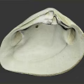 White Clam Shell With Oval Shape Textured Edge And Small Hole On Dark Background