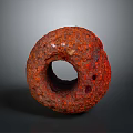 Natural Red Circular Wood Stone Artifact with Rough Texture and Holes