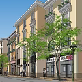 Scenic European Style Commercial Street With Multi Story Buildings Trees And Pedestrians