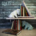 Decorative Ornament Set with White and Turquoise Dog Figurines on Wooden Shelf with Books