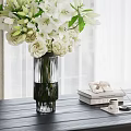 White Flowers In Transparent Glass Vase On Dark Wooden Table With Decorative Books And Tray