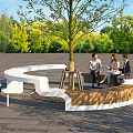 Curved White And Wooden Landscape Seating Around Tree In Green Outdoor Area