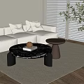 Modern Black Marble Coffee Table With Cylindrical Base Light Sofa And Pillows In Living Room