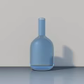 Light Blue Transparent Glass Vase Placed on Gray Desktop with Light Background Wall