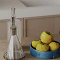Kitchen Wooden Tabletop With Transparent Glass Decanter And Bowl Of Yellow Apples