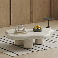 Irregular Marble Coffee Table with Cylindrical Legs Metal Bowl Fruits and Small Decorative Sculpture on Rug
