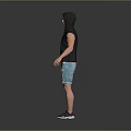 Man In Hooded Sleeveless Top And Distressed Denim Shorts With Sneakers Standing Against Gray Background