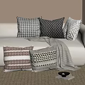 Neutral Toned Sofa With Geometric Pattern Throw Pillows And Gray Blanket