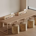 Natural Wooden Long Table With Log Stools In Simple Indoor Space With Window Blinds