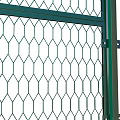Green Metal Security Fence With Diamond Mesh Design And Spiked Top Supported By Vertical Posts