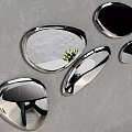 Multiple Irregular Shaped Mirrors On Gray Wall With Black Table Green Legs Blue Stool And Flowers