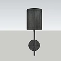 Modern Wall Lamp With Cylindrical Gray Fabric Shade And Metal Arm On Light Wall